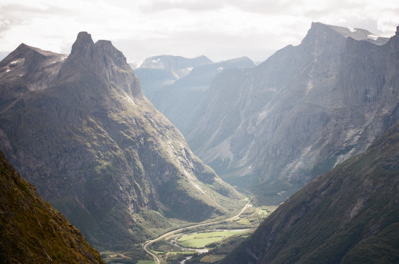 A deep mountain valley with a road winding through it